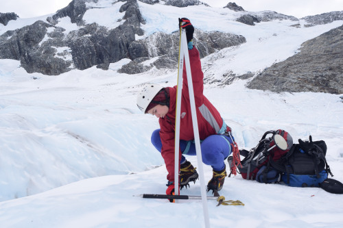 Dr Vargo using equipment to measure Brewster Glacier's ice loss from previous years