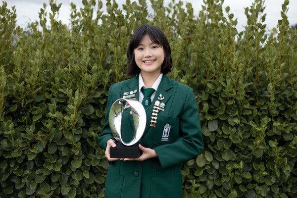 Carol in front of hedge with trophy Large