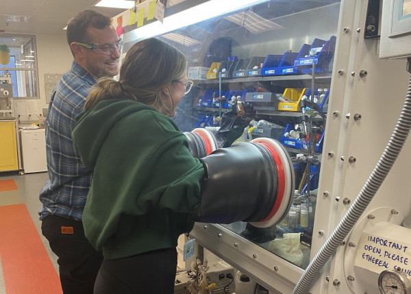 Edit V2 1st image PI Anker and Tylah Sweet PhD working in a glove box on the first generation of molecular indium phosphide two scientists working at a glove box