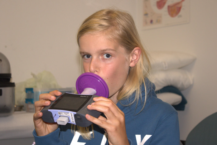 Study participant conducting lung function testing Study participant conducting lung function testing